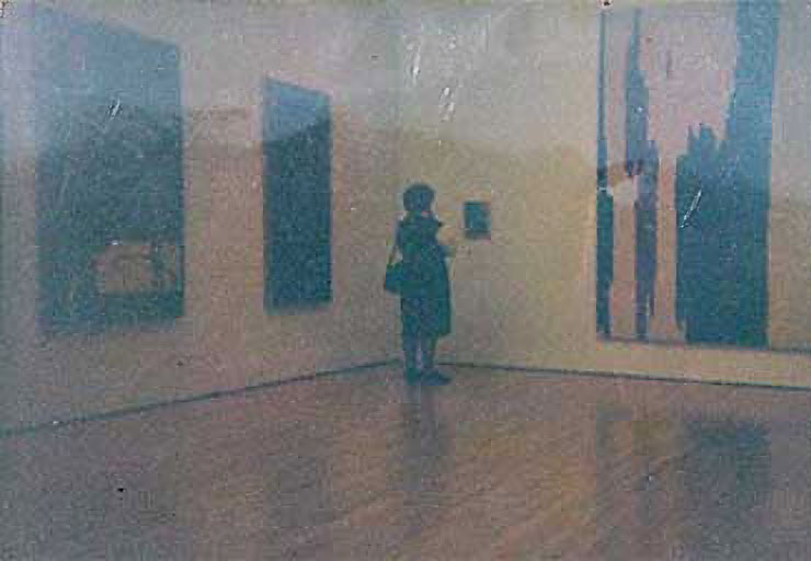 Museum guest pondering the small painting